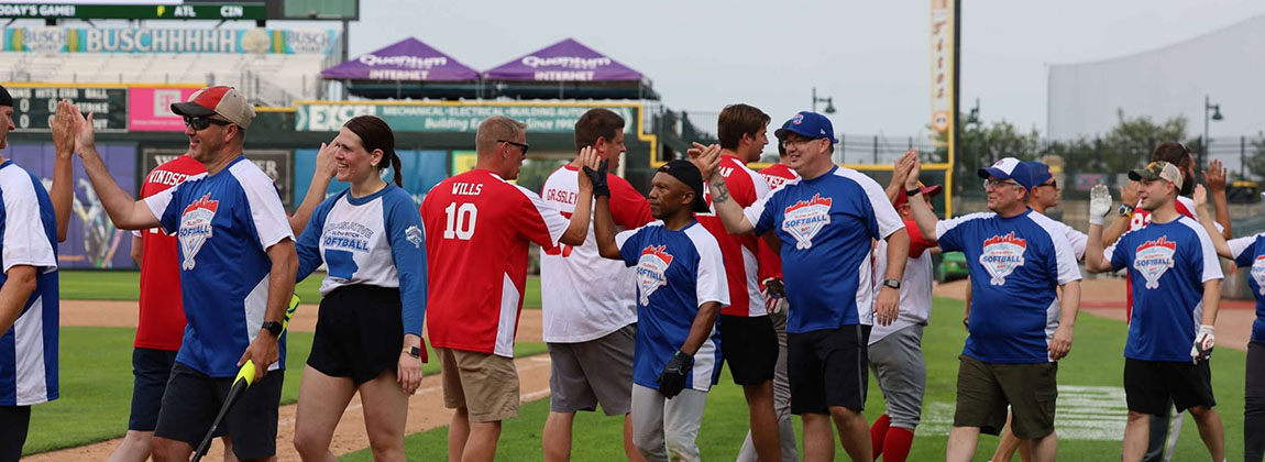 Two teams giving each other high fives